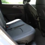 Rear seat passenger view in 2026 Kia Sportage showing spacious legroom, comfortable seating position, and premium interior appointments for second-row occupants