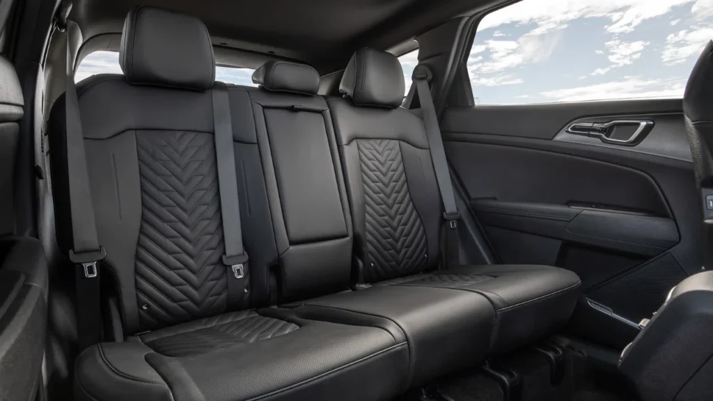 Rear seating area of 2026 Kia Sportage showing 60/40 split-folding seats with SynTex leatherette upholstery, quilted pattern, and spacious legroom for passengers