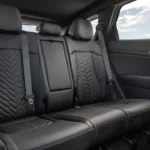 Rear seating area of 2026 Kia Sportage showing 60/40 split-folding seats with SynTex leatherette upholstery, quilted pattern, and spacious legroom for passengers